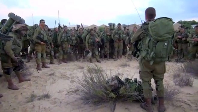 An image supplied by the Israeli Defense Forces shows Israeli infantry soldiers as they receive a briefing inside the Gaza Strip Friday.
