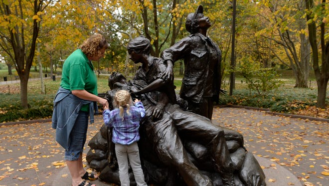 Sara Orndorff and Morganne Miller, 5, visit the Vietnam Women's Memorial Nov. 7. This year's Veterans Day observance will celebrate the 20th anniversary of the monument.