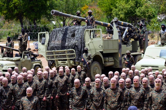 Fighters from the Lebanese militant group Hezbollah carry out a training exercise in Aaramta village in the Jezzine District, southern Lebanon, on May 21, 2023.