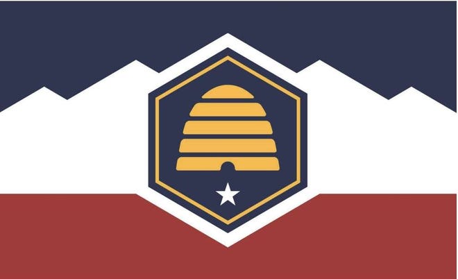 The new state flag for Utah includes symbols for red rock, snowy mountains, blue skies and an industrious beehive. The five-pointed star beneath the beehive was proposed to represent the state's five historic Native American tribes.