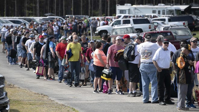 Race fans wait in line to purchase tickets at the Ace Speedway on in the rural Alamance County community of Altamahaw near Elon, N.C., on May 23. North Carolina Gov. Roy Cooper’s administration has ordered the closure of the small stock-car track, which has allowed large crowds to gather repeatedly for weekend races well above state COVID-19 limits for mass gatherings.