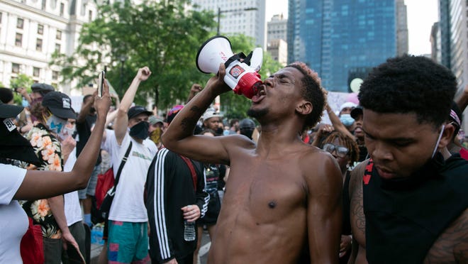 Nasir Bell rallies demonstrators by City Hall in Philadelphia on June 6 during protests against the killing of George Floyd. The city’s health commissioner says there is concern the protests will lead to a spike in COVID-19 infections in the city.