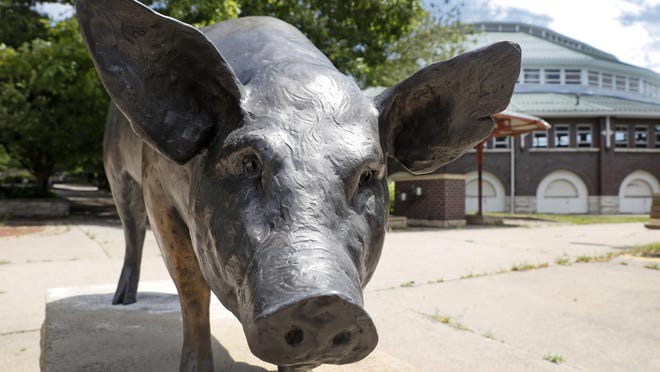 A statue of a hog stands in front of a livestock pavilion on the Iowa State Fairgrounds in Des Moines. This summer’s Iowa State Fair was canceled Wednesday because of coronavirus concerns, marking the first time since World War II that the annual gathering won't be held in Des Moines.
