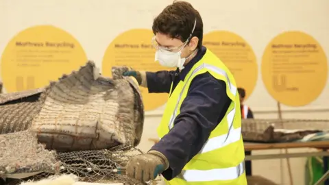 Jim Corr Man ripping open a mattress
