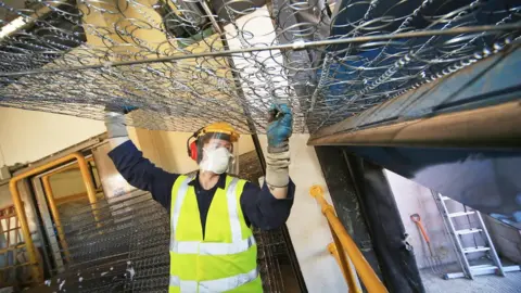 Jim Corr Man carrying a mattress