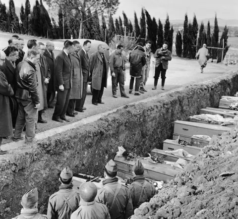 Getty Images French politicians visit the cemetery at Frejus, where victims of the the Malpasset Dam collapse were buried