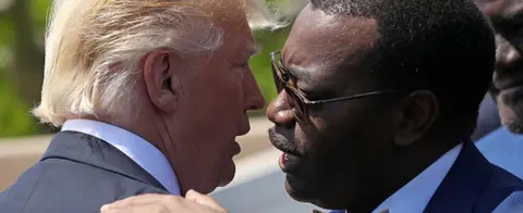 Getty Images Akinwumi Adesina (R) and Donald Trump