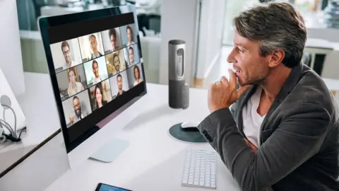 Zoom A man talks to 12 colleagues on Zoom's video conferencing app
