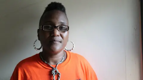 BBC Erricka Bridgeford stands at the window of her childhood bedroom