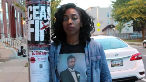 BBC Brittany Oliver stands near the spot where her uncle, David Lamont Hill, was shot to death a year ago
