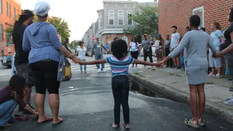 BBC Prayer circle at site of Saturday's homicide