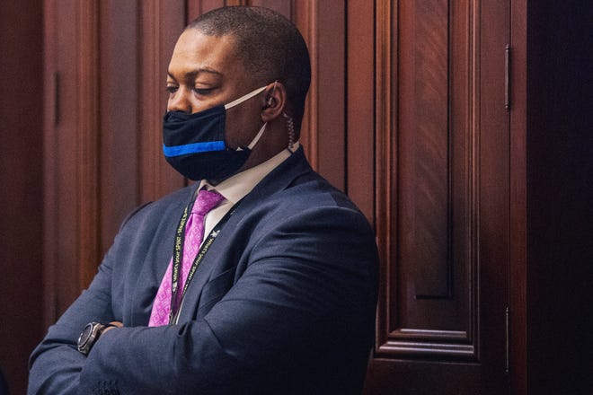 U.S. Capitol Police Officer Eugene Goodman watches never-before-seen security footage of rioters storming the Capitol on Jan. 6, during the second day of former President Donald Trump's second impeachment trial on Wednesday. Goodman, who has been lauded as a hero, warned Sen. Mitt Romney, R-Utah, the rioters were headed his way. Goodman also directed the mob away from the Senate chamber and toward other officers.
