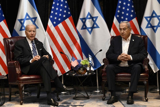 US President Joe Biden (L) listens to Israel's Prime Minister Benjamin Netanyahu as he joins a meeting of the Israeli war cabinet in Tel Aviv on Oct.18, 2023, amid the ongoing battles between Israel and the Palestinian group Hamas. US President Joe Biden landed in Tel Aviv on Oct. 18, 2023, as Middle East anger flared after hundreds were killed when a rocket struck a hospital in war-torn Gaza, with Israel and the Palestinians quick to trade blame.