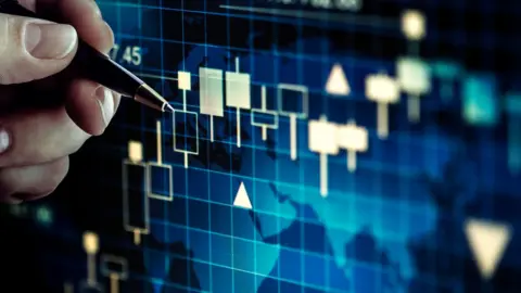 Getty Images A man holding a pen