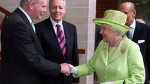 PA The Queen and Martin McGuinness shake hands