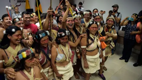 Getty Images Waorani indigenous people celebrate after a court ruled in their favour on the tribe's legal challenge to the government's land selloff, at the end of the protection action hearing in Puyo, Ecuador, on April 26, 2019.