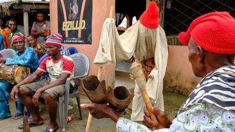 Getty Images Men sat during an Igbo meeting