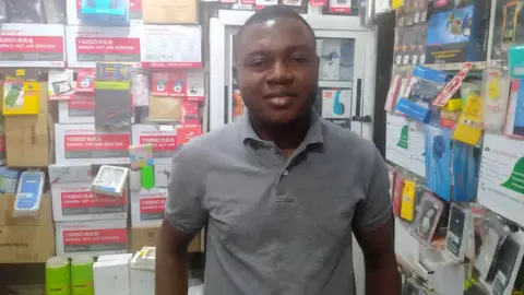 BBC Onyeka Orie inside his phones' accessories shop