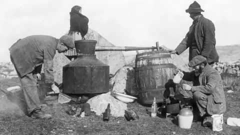 Getty Images Men producing poitin in the 19th Century