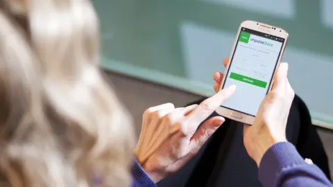 True Potential A woman using True Potential's app