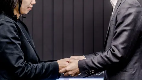 Getty Images File picture of male and female colleagues