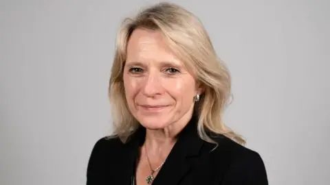 Government of Jersey Elaine Miller looking at the camera wearing a black jacket