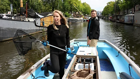 Mike MacEacheran Tour company Plastic Whale is pulling plastic and other rubbish from Amsterdam's canals (Credit: Mike MacEacheran)