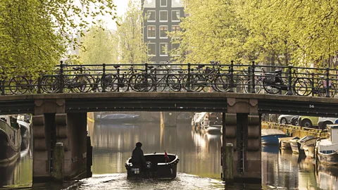 Peter Adams/Getty Images Amsterdam's canals have long been a big draw for tourists (Credit: Peter Adams/Getty Images)