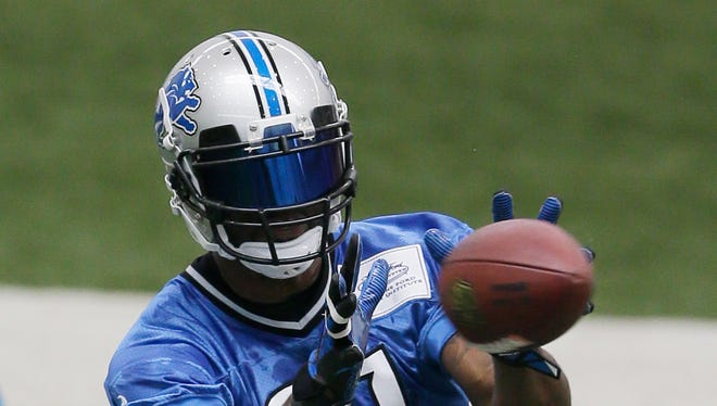 Detroit Lions NFL football wide receiver Calvin Johnson makes a catch during organized team activities at the Lions training camp facility in Allen Park, Mich., Wednesday, May 21, 2014.
