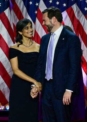 Vice President-elect J.D. Vance and his wife Usha Vance listen to President-elect Donald Trump speak at an election night event at the West Palm Beach Convention Center in West Palm Beach, Fla.