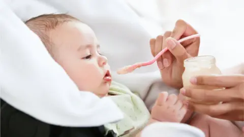Getty Images Baby being fed