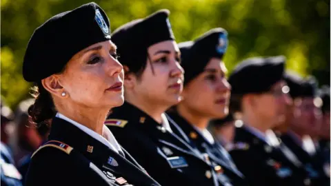 The Washington Post via Getty Images Chief Warrant Officer Four, Rosemary Masters, of Oklahoma Army National Guard, left, listens to the speaker during the 20th Anniversary of Women In Military Service For America Memorial celebration on Saturday, October 21, 2017, at the Arlington National Cemetery in Arlington, VA.