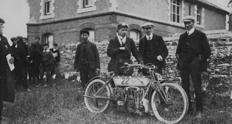 Getty Images Rem Fowler with a 5 hp Peugeot-engined Norton motorcycle