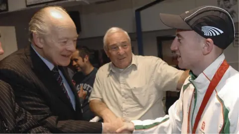 PA Media Barney Eastwood pictured in 2008 alongside boxer Paddy Barnes