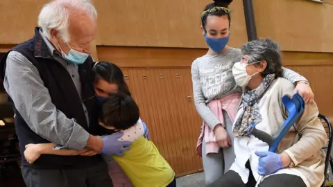 EPA Melia Famoso (R) and her husband Giovanni hug their grandchildren after almost two months social distancing due to the lockdown measures to face the COVID-19 coronavirus pandemic, in San Donato Milanese, near Milan