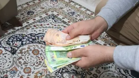 Elham Noor Noor counting cash