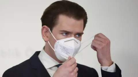 Reuters Austria's Chancellor Sebastian Kurz removes a face mask as he attends a news conference on 1 March