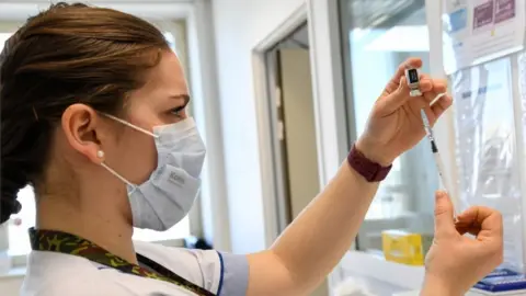 Reuters A healthcare worker prepares a dose of a COVID-19 vaccine at a vaccination centre in the HIA Begin military hospital, in Saint-Mande, southeast of Paris