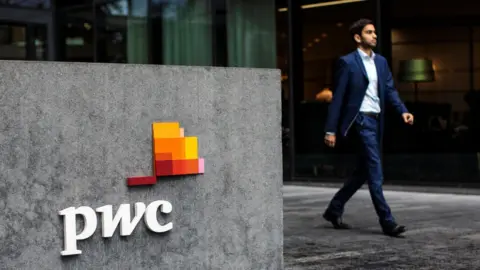 Getty Images PwC sign and man walkign by 2018