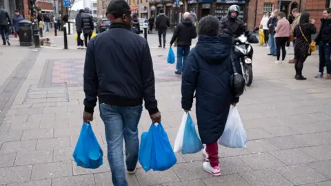 Getty Images person with carrier bags