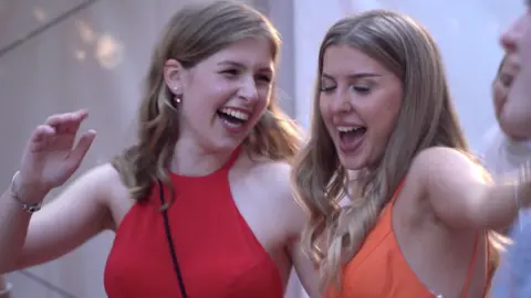 Alisa Gukasov (R) and classmate celebrate the end of school