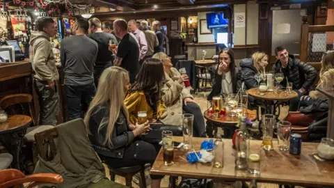 Getty Images People enjoying themselves in a pub in Stalybridge