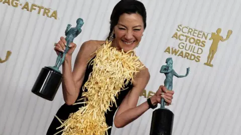 Reuters Michelle Yeoh poses with two SAG statuettes