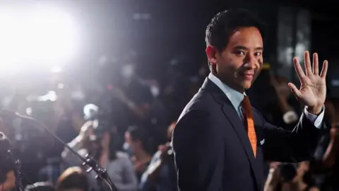 Reuters Move Forward Party leader and prime ministerial candidate, Pita Limjaroenrat, waves during a press conference following the general election