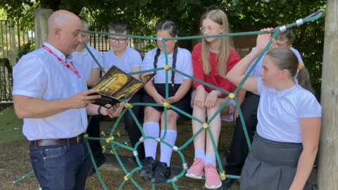 BBC Carl Heslop reading to pupils