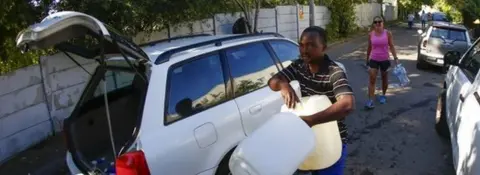 EPA Residents of Cape Town carry plastic bottles to collect drinking water from a mountain spring collection point in Cape Town, South Africa, 17 January 2018.