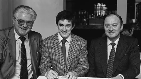 Pacemaker Barry McGuigan signing professional forms with Barney Eastwood in 1981