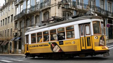 Reuters People wearing masks in Lisbon