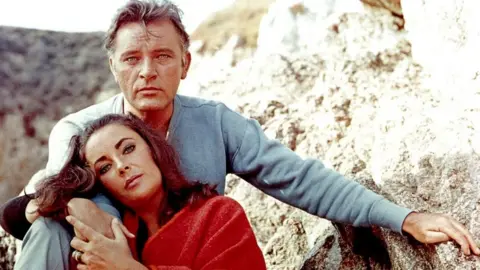 Getty Images Elizabeth Taylor and Richard Burton on the film set of "The Sandpiper" in 1965.