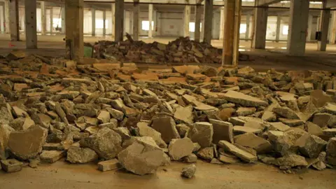Wang Xiqing/BBC Rubble inside factory